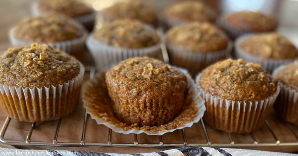 Close-up of Superfood Breakfast Muffins on cooling rack with wrapper peeled away on one.