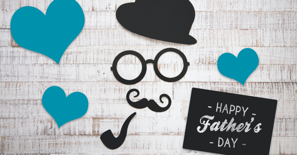 Image of a Happy Father's Day sign and some paper cut-outs laying on a table.