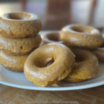 Simple Baked Pumpkin Donuts stacked on platter on wooden tray.